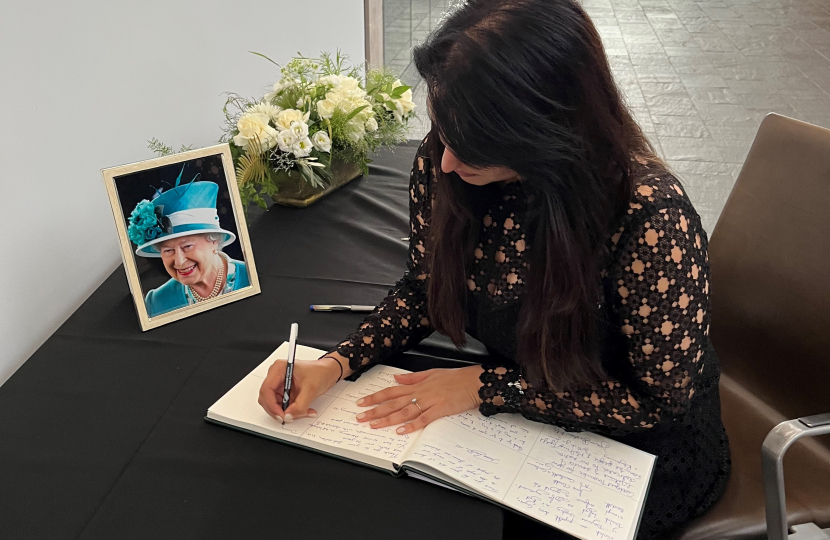 Natasha Asghar MS writing in a book of condolences.