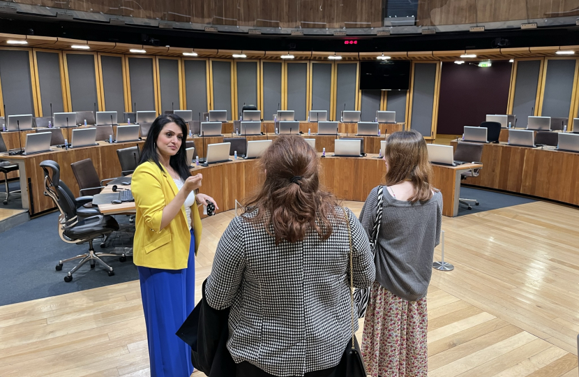 Natasha Asghar MS giving students a tour of the Senedd chamber.