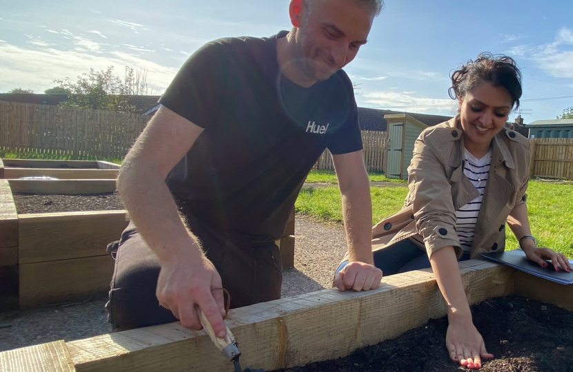 Natasha helps Toby from United Response plant bulbs 