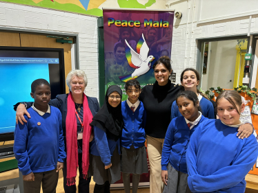 Natasha Asghar MS with Pam Evans MBE and pupils at Maindee Primary School.